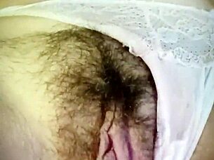 Milf shows off her wet hairy pussy in bedroom