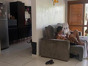 Husband in kitchen, wife with friend