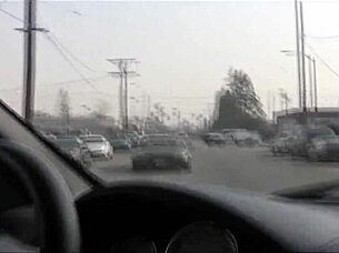 Amina Sky in heels fingering her shaved pussy on the bed