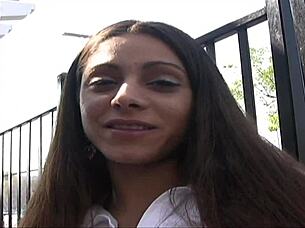 Amina Sky in heels fingering her shaved pussy on the bed