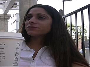 Amina Sky in heels fingering her shaved pussy on the bed