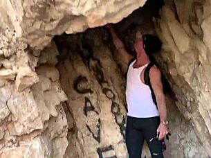 in a cave, she performs outdoor blowjob on monster cock, risking public exposure