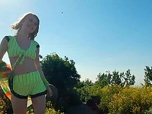 Spunky teen model strips naked during steamy outdoor photoshoot.