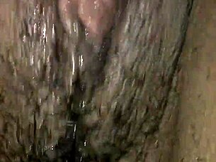 Ebony woman plays with wet pussy using vibrator and toys, teasing monster cock