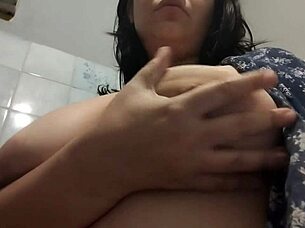 I masturbate in the bathroom, she whispers while touching her wet pussy.
