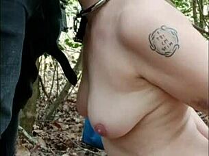 Female slave walks in forest and engages in dogging on April 16, 2025.