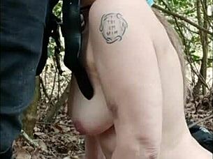 Female slave walks in forest and engages in dogging on April 16, 2025.