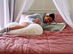 the cute asian girl starts humping her pillow in a solo masturbation session