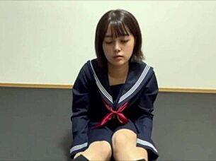 small asian girl introduces underwear while hiding body with towel