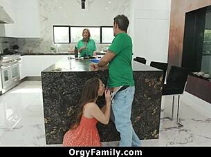The stepdaughter sucked her daddy's cock behind the kitchen counter while the stepmom was busy with the orgy family activities.