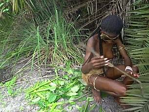 hot african native woman cooking in the jungle kitchen