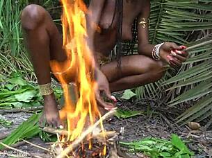hot african native woman cooking in the jungle kitchen