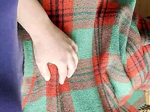 My shy neighbor performs cunnilingus under the blanket in this homemade lesbian scene.