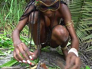 hot african native woman cooking in the jungle kitchen