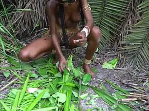 hot african native woman cooking in the jungle kitchen