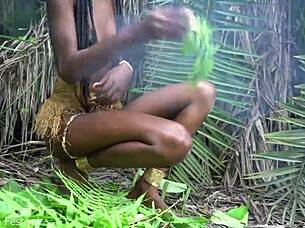 hot african native woman cooking in the jungle kitchen