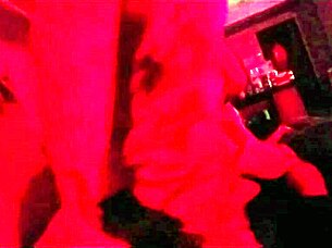 The pretty girl enjoys a fun party with friends under red lights