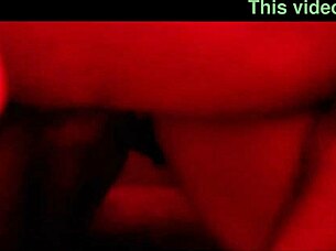 The pretty girl enjoys a fun party with friends under red lights