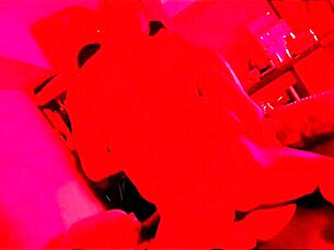 The pretty girl enjoys a fun party with friends under red lights