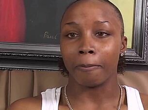 Intense lesbian action as ebony and redhead kiss, finger, and use strapon passionately.