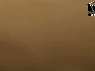 Redhead milf gives a blowjob to Rubens Badaro in this casual scene.