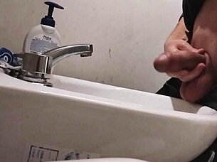 Resting balls on the sink while preparing cock for a huge cumshot.
