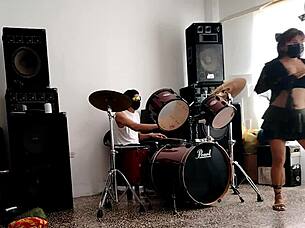 Latina strips and shakes ass to drums.