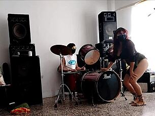 Latina strips and shakes ass to drums.