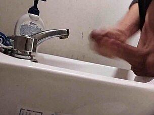 Resting balls on the sink while preparing cock for a huge cumshot.