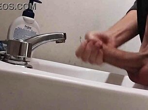 Resting balls on the sink while preparing cock for a huge cumshot.