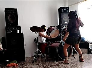 Latina strips and shakes ass to drums.