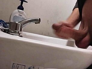 Resting balls on the sink while preparing cock for a huge cumshot.