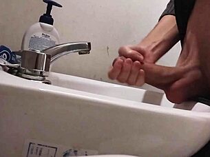 Resting balls on the sink while preparing cock for a huge cumshot.