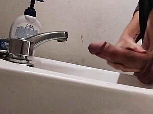 Resting balls on the sink while preparing cock for a huge cumshot.