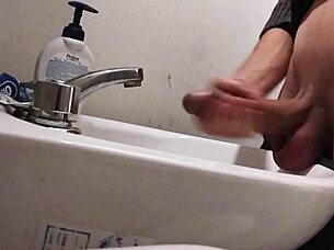 Resting balls on the sink while preparing cock for a huge cumshot.