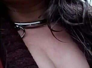 Female slave self-session in leather harness outdoors