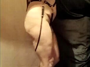 Female slave self-session in leather harness outdoors