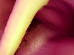 Curly-haired submissive lesbian in socks masturbates her natural tits and pussy with big dildo, achieving creamy cumshot