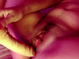 Curly-haired submissive lesbian in socks masturbates her natural tits and pussy with big dildo, achieving creamy cumshot