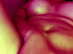 Curly-haired submissive lesbian in socks masturbates her natural tits and pussy with big dildo, achieving creamy cumshot