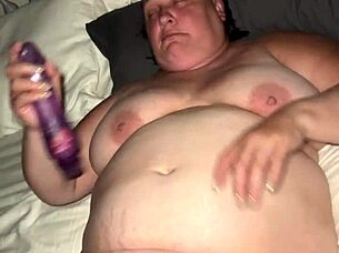 a fat bbw woman uses a vibrator to achieve orgasm in a private setting