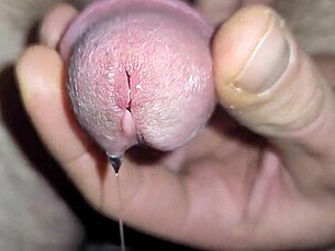 shimmering precum leads to ropes of cum in close up