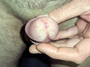 shimmering precum leads to ropes of cum in close up