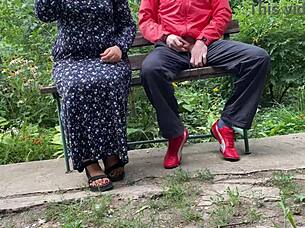 I can't believe this hot milf jerked off a big dick into a glass on the park bench