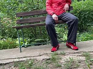 I can't believe this hot milf jerked off a big dick into a glass on the park bench