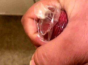 Watch me masturbating with a condom on my cock