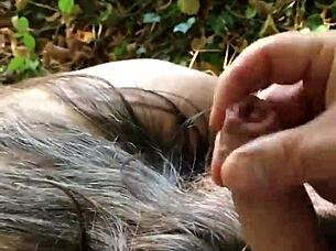 Slave bound in handcuffs gets spanked and pissed on outdoors