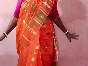 Curvy Indian beauty in traditional saree poses elegantly showcasing her natural charm.