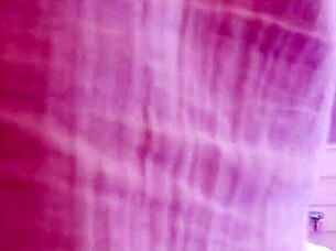 sofi finds herself bound with red ropes tightly on the soft bed in suspense