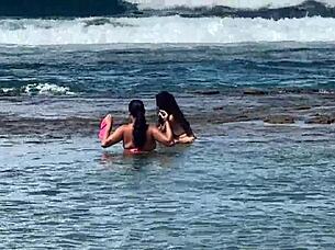 Two beautiful Brazilian women enjoy their first time kissing and exploring on the sunny beach. Their curvy bodies shine under the sun in this outdoor adventure.